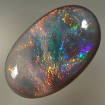 SOLID BLACK OPAL Bright reds over blue with orange and green
